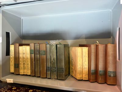 many books on a shelf in a small room