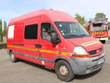 a red van parked in a parking lot with a firetruck in the background