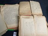 several old books are stacked on top of each other on a table
