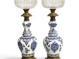 pair of blue and white vases with a brass base