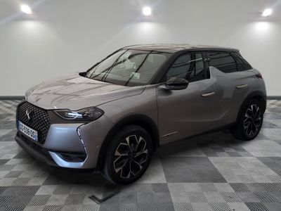 the front of a silver suv parked on a checkered floor