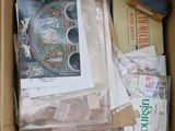 a cardboard box filled with assorted items and papers