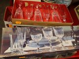 a box of empty wine glasses sitting on a table
