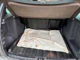 the back of a car with a mattress in the trunk of it