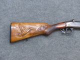 an old gun with a bird engraved on it laying on the ground