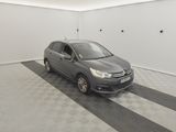 the grey car is parked in the garage on the checkered floor