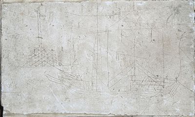 a stone slab with a drawing of a boat on it
