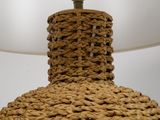 a lamp that is made out of rope and a light bulb