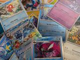 a lot of pokemon cards that are on the table