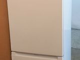 un réfrigérateur blanc posé sur une palette dans un entrepôt