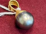 a picture of a ring and a pearl on a red cloth