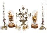 a lot of glass vases and candles on the table