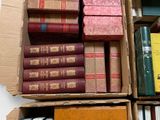 boxes of books are stacked on top of each other on a table