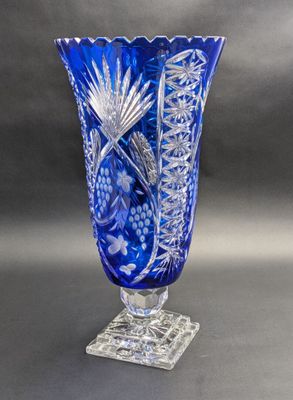 an image of a blue glass vase sitting on top of a table