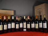 many bottles of wine sitting on a table next to a wooden box