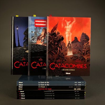 three books are stacked on top of each other in front of a dark background