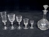 a lot of wine glasses and a decanter on the table