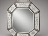 a white and silver mirror sitting on top of a table
