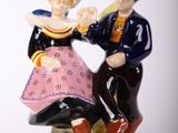 a figurine of a man and a woman sitting on a bench