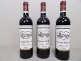 trois bouteilles de vin posées sur une table l'une à côté de l'autre