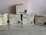 several empty wine glasses sitting on top of a table next to boxes of wine