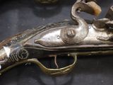 a very old gun that is on display in a glass case