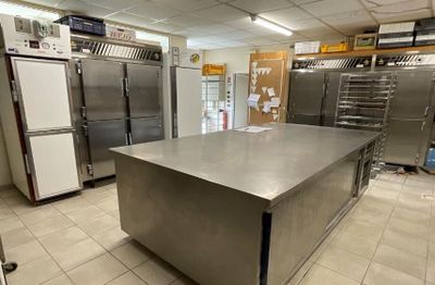 a large kitchen with stainless steel appliances in it