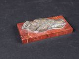 a close up of a red marble box on a black surface