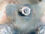 a close up of a metal object with nuts on it