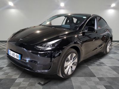 the black tesla vehicle is parked in the garage