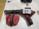a cordless drill and a cordless hammer on a table