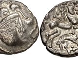 a silver coin with an image of a horse and rider on it