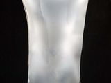a glass vase that is sitting on a black table