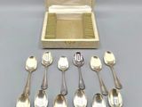 a lot of silver spoons and spoons in a box