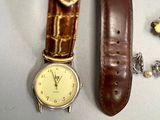 two watches and a necklace on a table
