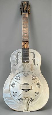 a white guitar that is sitting on a table