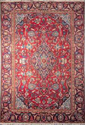 an antique persian rug with red and blue colors