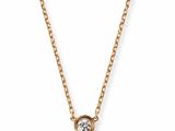 a gold necklace with a single diamond on a chain