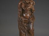 a wooden statue of a woman holding a child