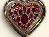 an image of a heart shaped brooch with a lot of red stones