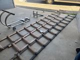 a metal bed frame laying on the ground next to a truck