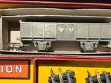 two boxes of toy trains sitting on top of each other
