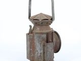 an old rusted metal oil can with a handle on a white background
