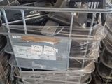 a pile of computer equipment sitting on top of a pile of pallets
