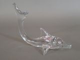 a glass sculpture of a fish on a table