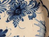 a blue and white plate with a floral design on it