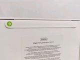 a white refrigerator with a green sticker on it