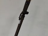 a close up of a wooden stick with a metal handle