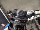 a person holding a camera lens in their hand