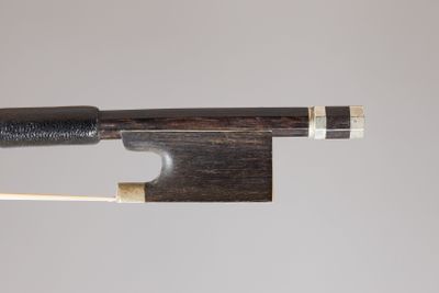 a close up of a violin bow with a wooden stick sticking out of it